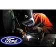 Ford logo near welder in orange jacket performing precision metal welding