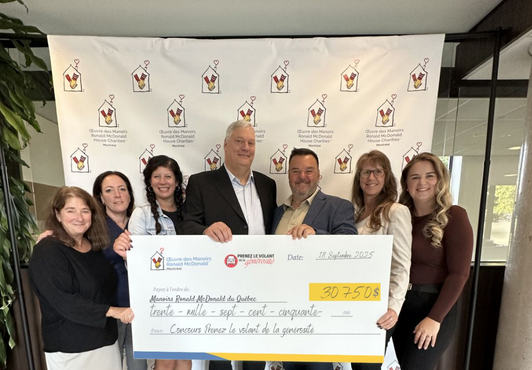 Group presenting large donation check for Ronald McDonald House Charities