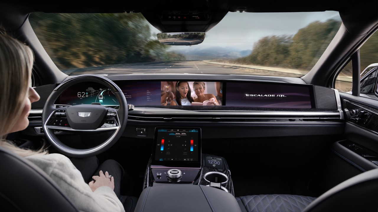 Cadillac Escalade interior dashboard with driver's perspective on scenic mountain road