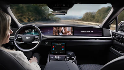 Cadillac Escalade interior dashboard with driver's perspective on scenic mountain road