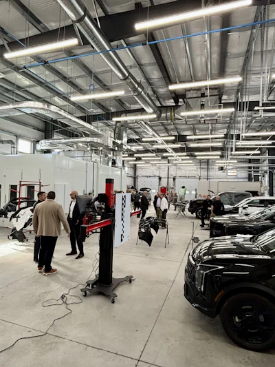 Interior of automotive service center with black vehicles and technical equipment