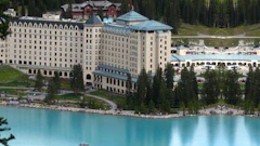 Fairmont Chateau Lake Louise in Banff National Park, with turquoise lake and mountain forest backdrop