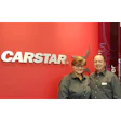 CARSTAR automotive service logo with two employees in matching shirts