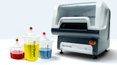 Laboratory mixing machine with colorful measurement containers in red, yellow, and blue