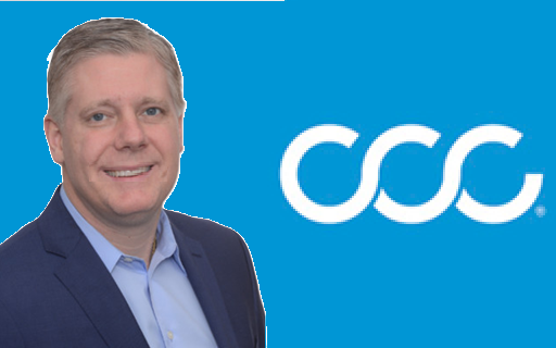 Professional businessman posing next to CCC corporate logo