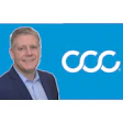 Professional businessman posing next to CCC corporate logo