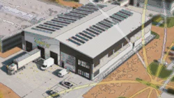Aerial view of modern industrial building with solar panels and parking area