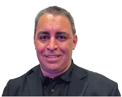 Smiling professional in black blazer and shirt against white background