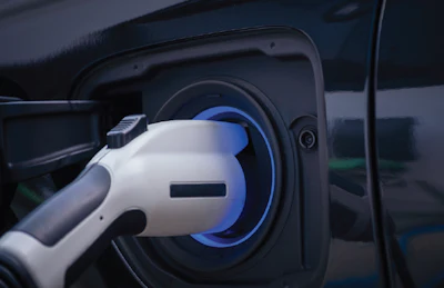 Electric vehicle charging cable connected to car charging port