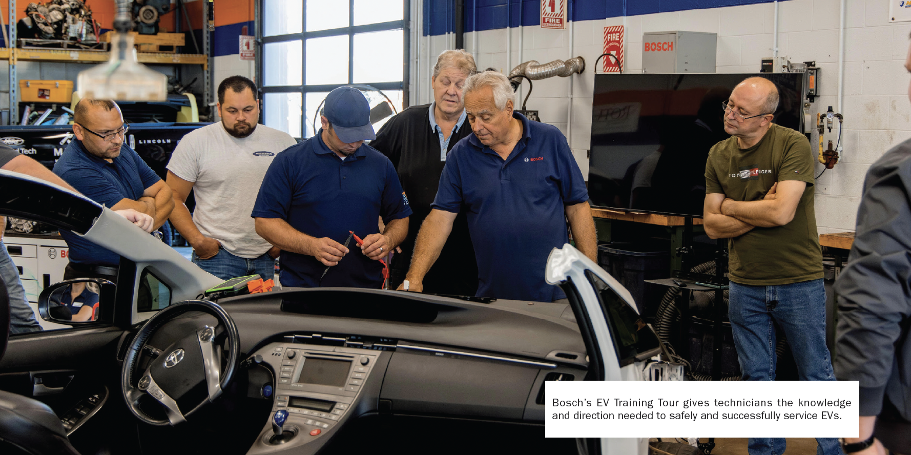 Automotive technicians examining a vehicle during Bosch EV training workshop