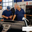 Automotive technicians examining a vehicle during Bosch EV training workshop