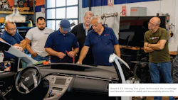 Automotive technicians examining a vehicle during Bosch EV training workshop
