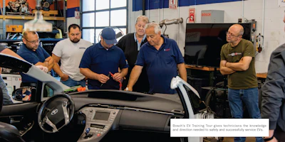 Automotive technicians examining a vehicle during Bosch EV training workshop