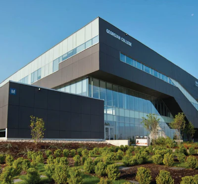 Modern glass and dark-paneled Georgian College building with landscaped grounds