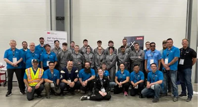 3M team group photo with employees in blue and gray shirts at workplace event