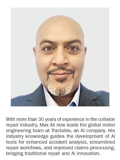 Professional headshot of a bald man in a blue suit and tie