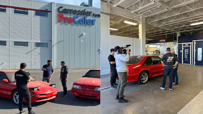 Red sports car inside auto body shop with camera crew and technicians