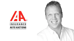 IAA Insurance Auto Auctions corporate logo with smiling professional in white shirt
