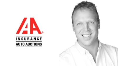 IAA Insurance Auto Auctions corporate logo with smiling professional in white shirt