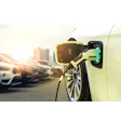 Electric vehicle charging at parking lot with urban background