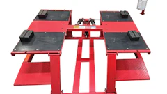 Red and black automotive vehicle alignment lift with hydraulic platform