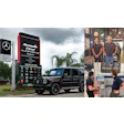 Mercedes-Benz dealership sign with black G-Wagon and automotive repair center logos