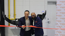 Two professionals cutting a red ribbon at Simplicity corporate event