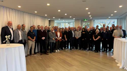 Large group of professionals gathered in a bright, modern conference room