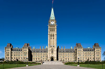 Canadian Parliament Centre Block with Peace Tower on bright blue sky day