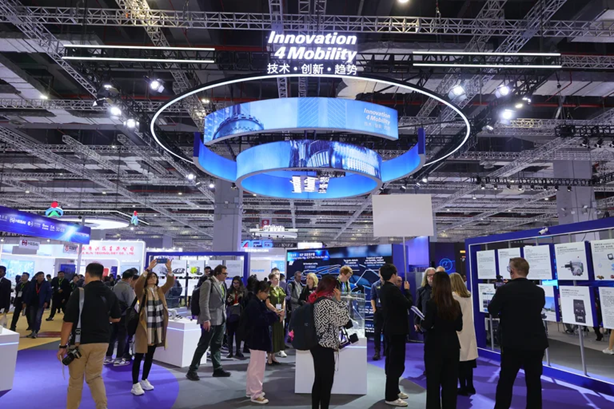 Technology conference with blue circular display and attendees exploring exhibition hall