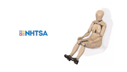 NHTSA logo next to articulated crash test mannequin on white background