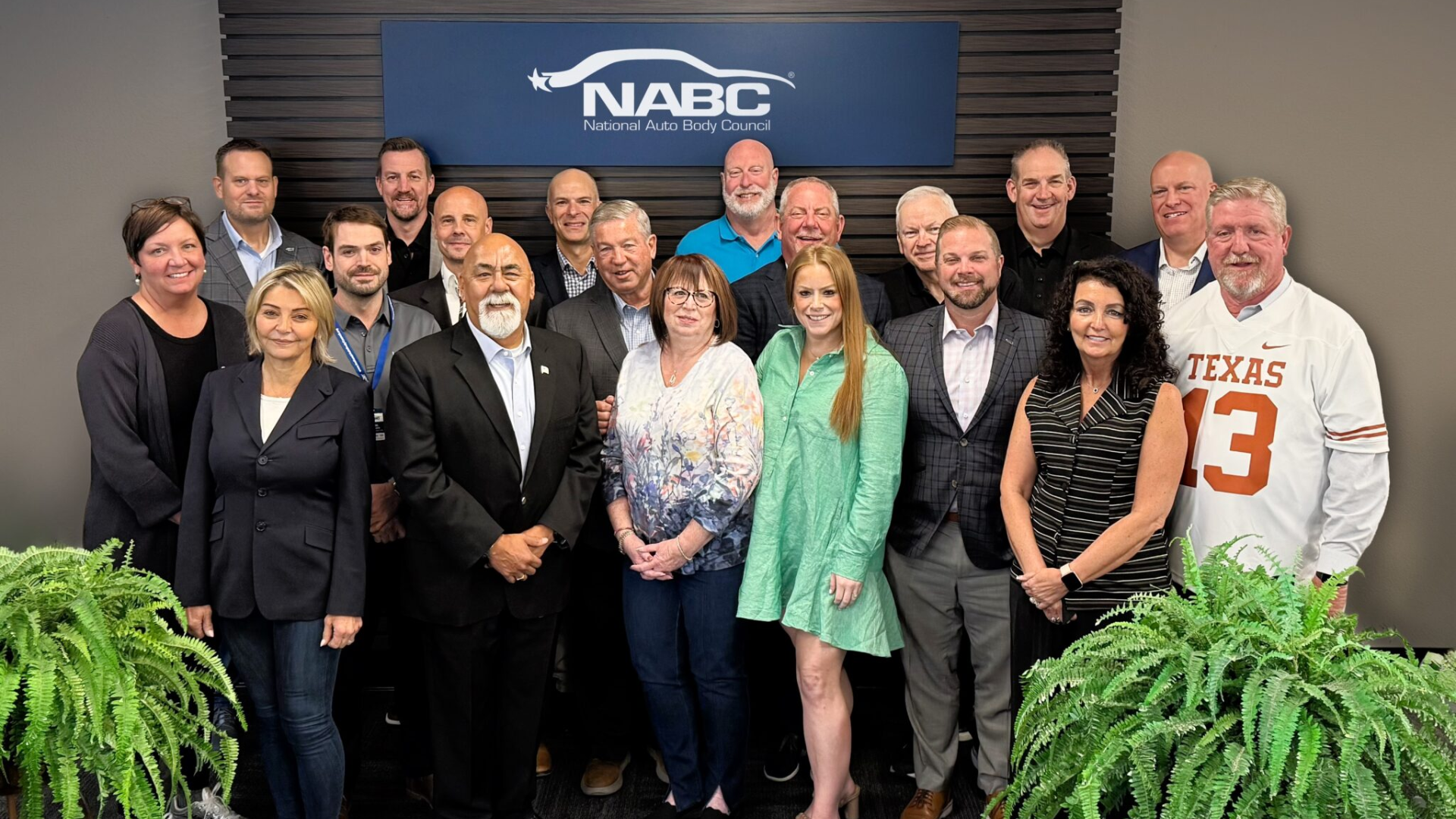 NABC group photo with team members posing in front of organizational logo