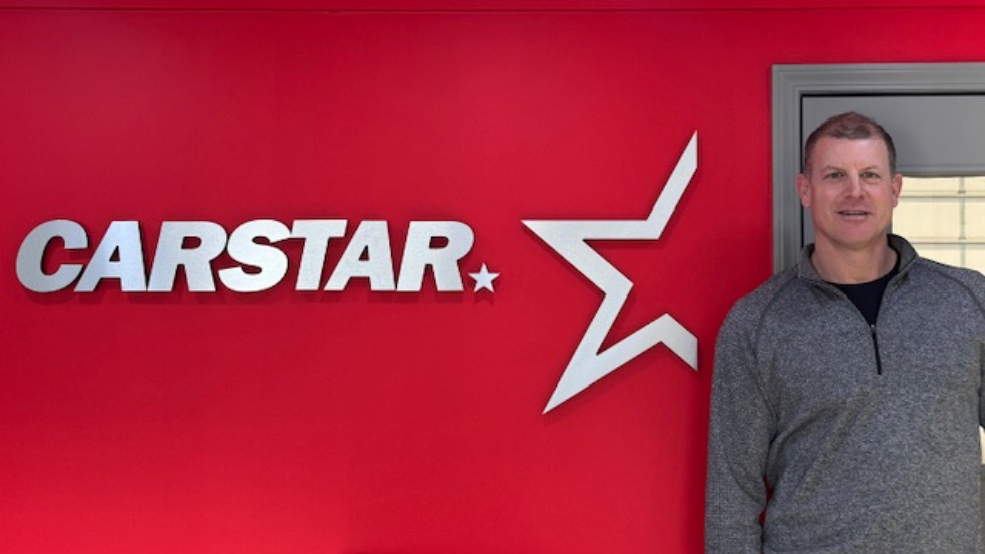 CARSTAR automotive repair logo with gray star symbol on bright red background