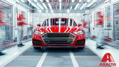 Bright red sports sedan in sleek automotive testing facility with Axalta branding
