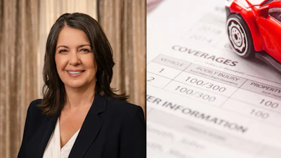 Professional woman in black blazer next to insurance document and red toy car