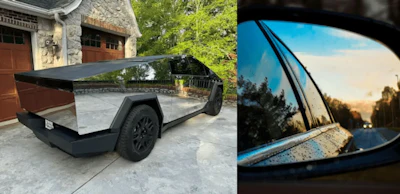 Sleek angular electric truck parked on concrete, with side mirror view of road