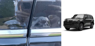 Black Toyota SUV parked beside blurry car window with reflective surface