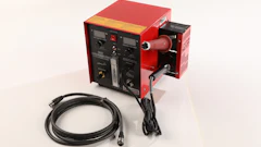 Red and black industrial power supply with digital control panel and black cables