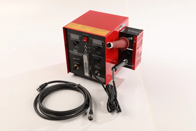 Red and black industrial power supply with digital control panel and black cables