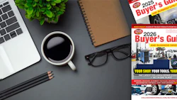 Workspace desk with laptop, coffee, pencils, and Buyer's Guide magazines