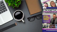 Workspace desk with laptop, coffee, magazine, and office accessories