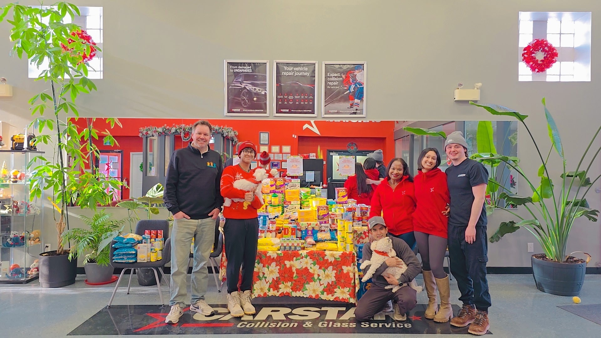 FIRST Collision team poses with holiday food donation display in their service center