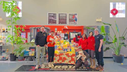 FIRST Collision team poses with holiday food donation display in their service center
