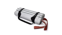 Gray rolled fabric or mat bundled with black straps and red strap