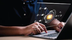 Hands typing on laptop with digital network visualization and glowing tech interface