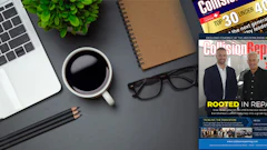 Workspace desk with laptop, coffee, magazines, plant, and glasses