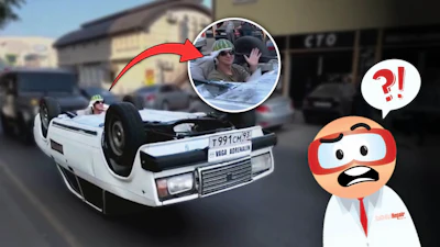 Overturned white car on street with shocked cartoon character reaction