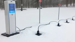 Electric vehicle charging station with power outlets in snow-covered winter landscape