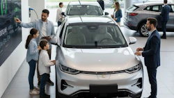 Family with children examining electric car in modern dealership showroom