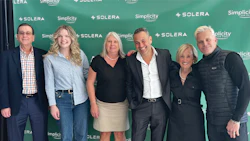 Six professionals posing in front of Solera and Simplicity corporate backdrop